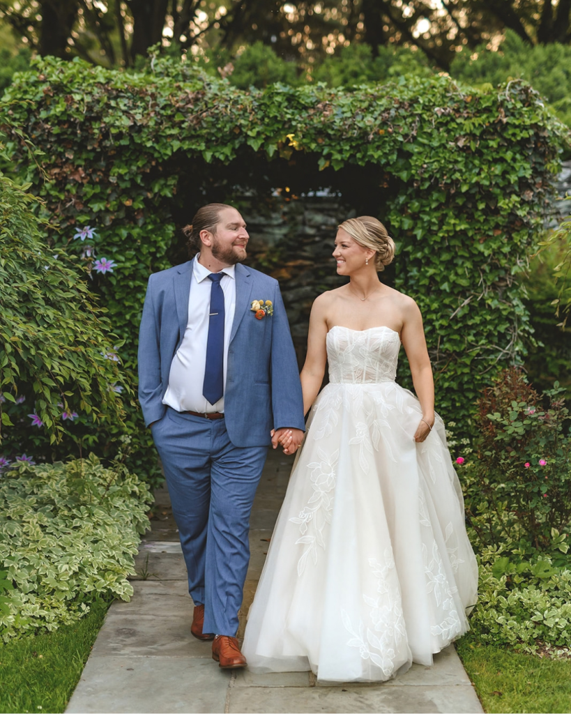 garden wedding bride and groom holding hands looking at each other