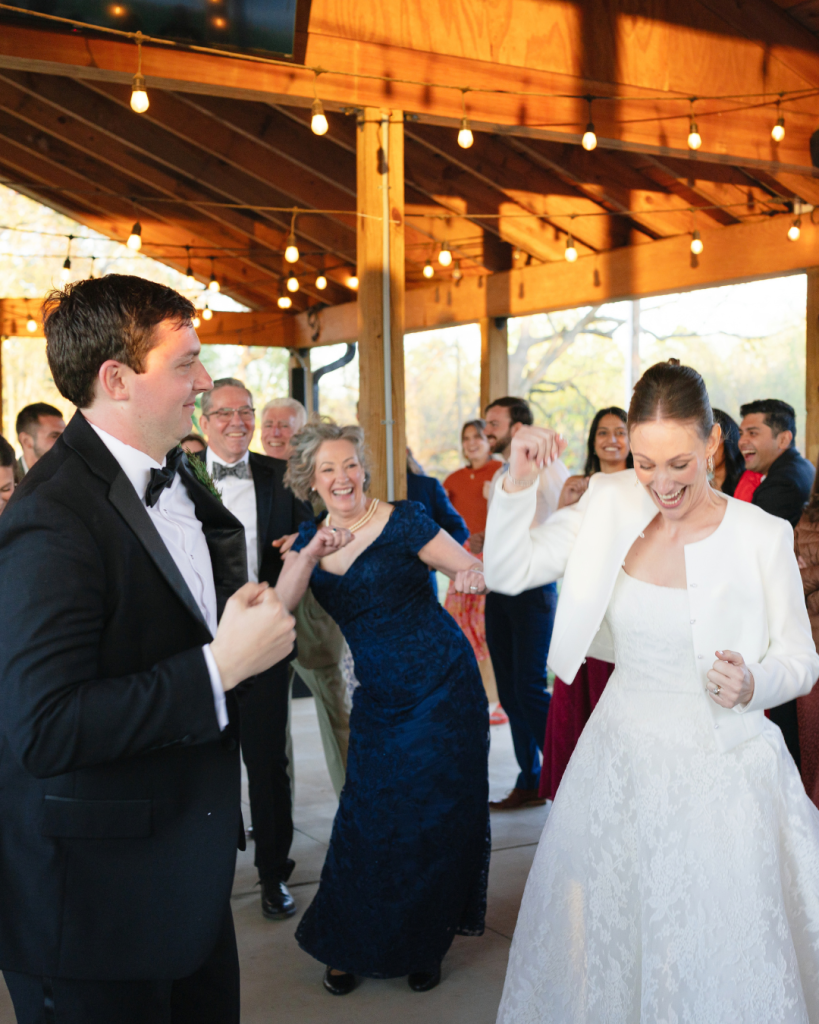 Tate and Alex dance with guests during their lively wedding reception at The Union Exchange.
