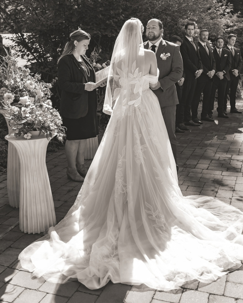 wedding ceremony with bride's dress featured