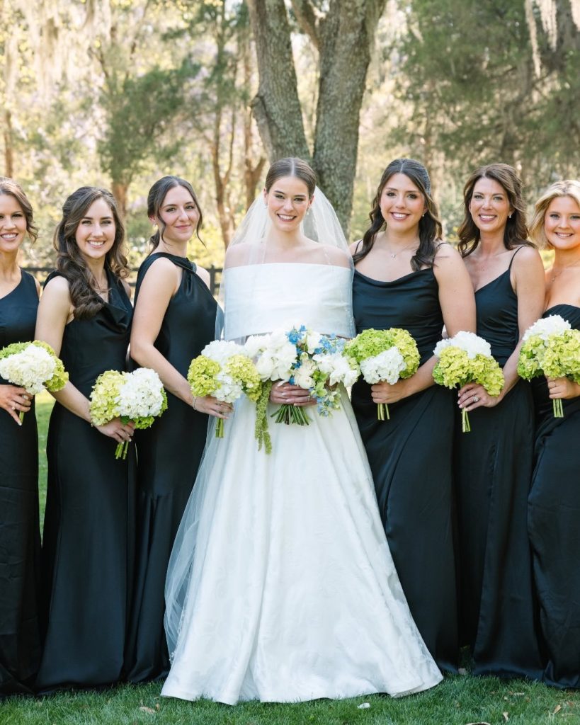 Bride and Bridesmaids in black dresses with green hydrangea bouquets, designed by Charlotte Grace Wedding Design