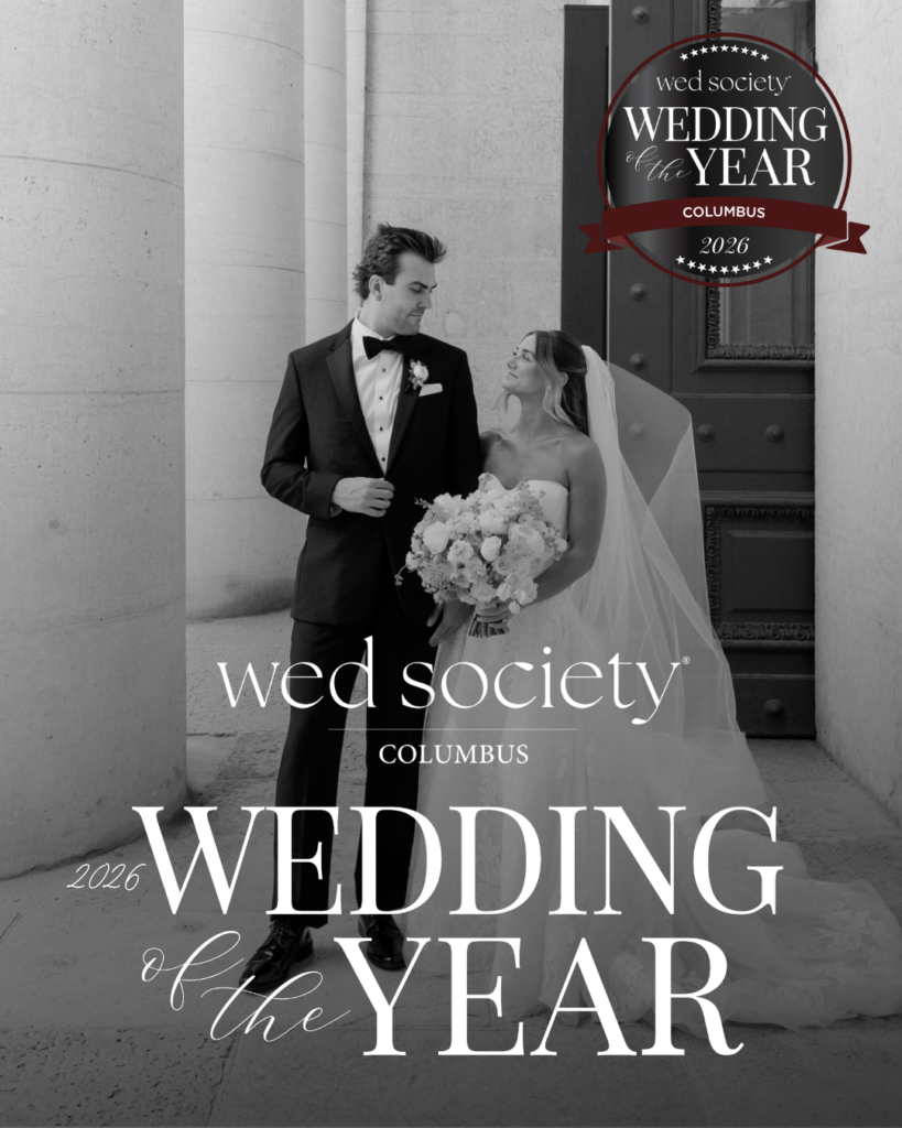2026 Wed Society Columbus Wedding of the Year winners Hannah and Ben pose outside The Ohio Statehouse in wedding attire with the award graphic overlay.