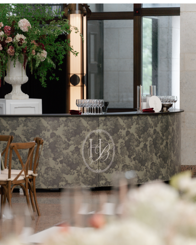 Custom floral-patterned wedding bar with Hannah and Ben's HB monogram, glassware and dramatic floral arrangements at The Ohio Statehouse.