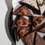 Assorted chocolate brownies and dessert bars topped with chocolate chip cookies, cream frosting, and glaze at Littleton’s Market in Columbus, Ohio.