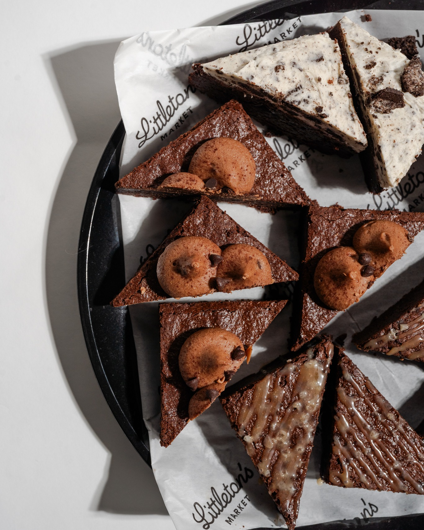 Assorted chocolate brownies and dessert bars topped with chocolate chip cookies, cream frosting, and glaze at Littleton’s Market in Columbus, Ohio.