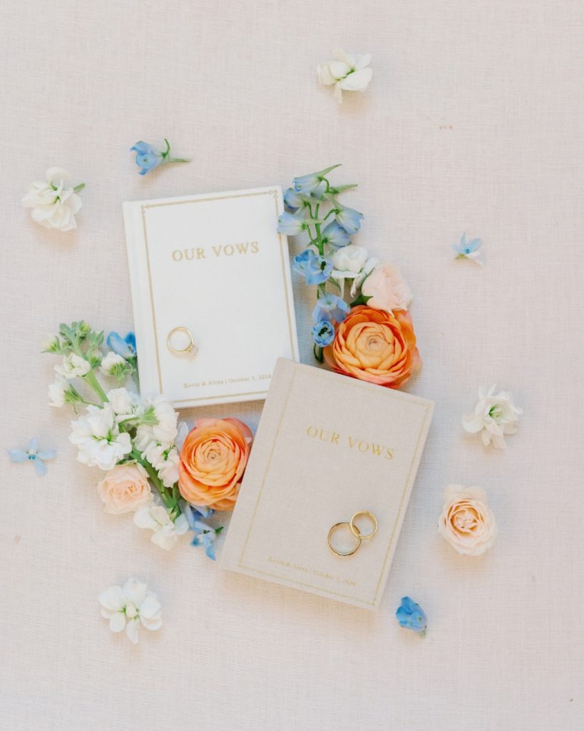 his and her our vows booklets with bright floral detail photo