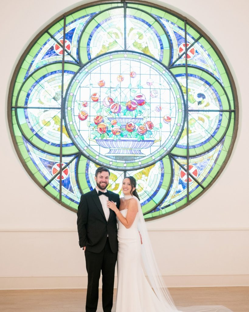 bride and groom in front of stained glass at The Elliot in Cleveland