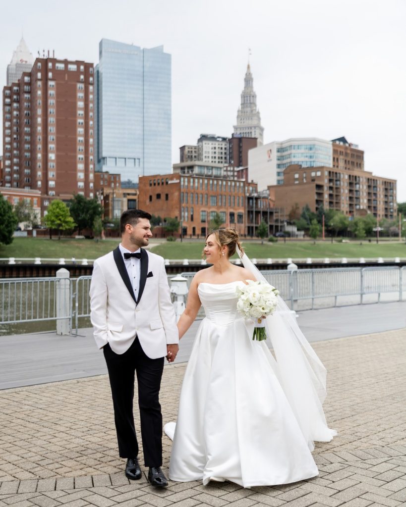 bride and groom walking downtown cleveland skyline
